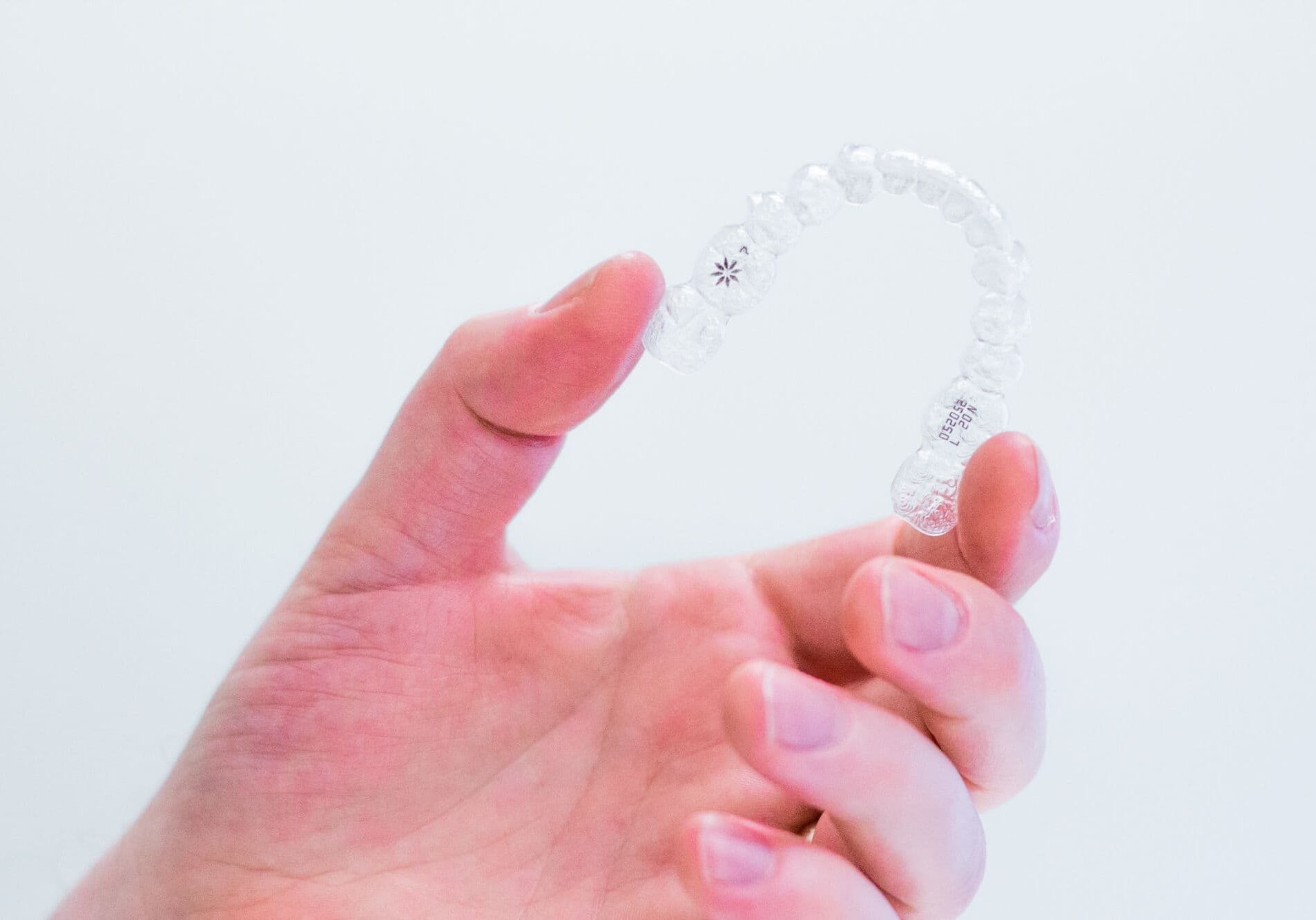 hand-holding-invisalign-aligners Invisalign for Teens